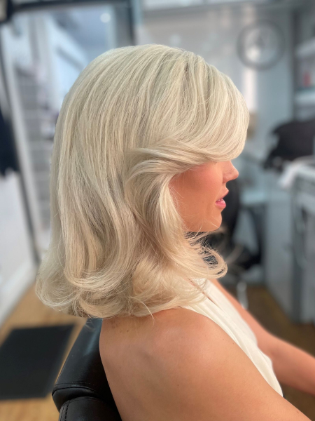 Actress Hayes Warner sits in the hair and makeup trailor for The Shards with her icy blonde hair blowdried and feathered.